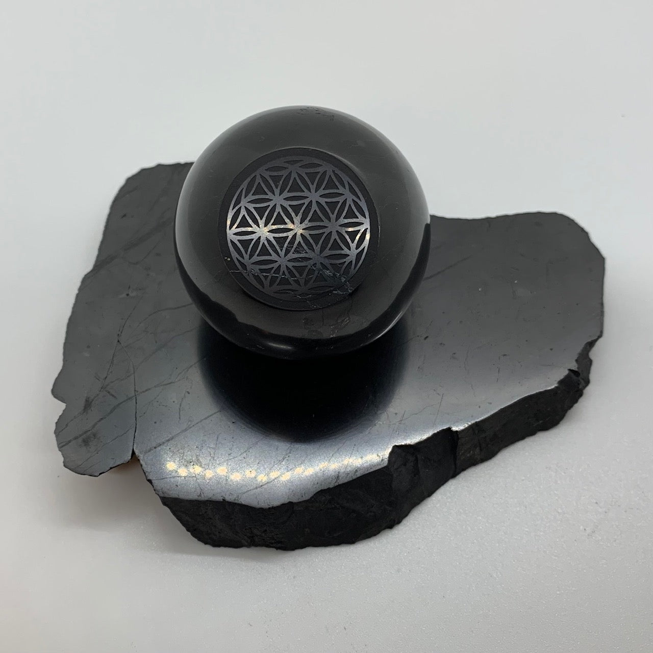 Polished Shungite Sphere Cut with Deep Engraving Flower of Life (5 cm)*